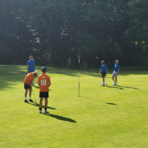 Reston National PGA Jr. League junior competing in a match putting on the green.