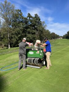 Maintenance works aerating the putting green