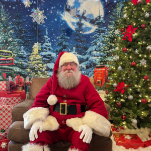 Santa Clause posing at Reston National Golf Course Breakfast with Santa event, featuring festive holiday decorations and holiday cheer.