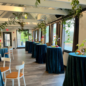 Festive holiday party décor inside Reston National Golf Course clubhouse, featuring garlands, lights, table settings, and seasonal decorations for events.