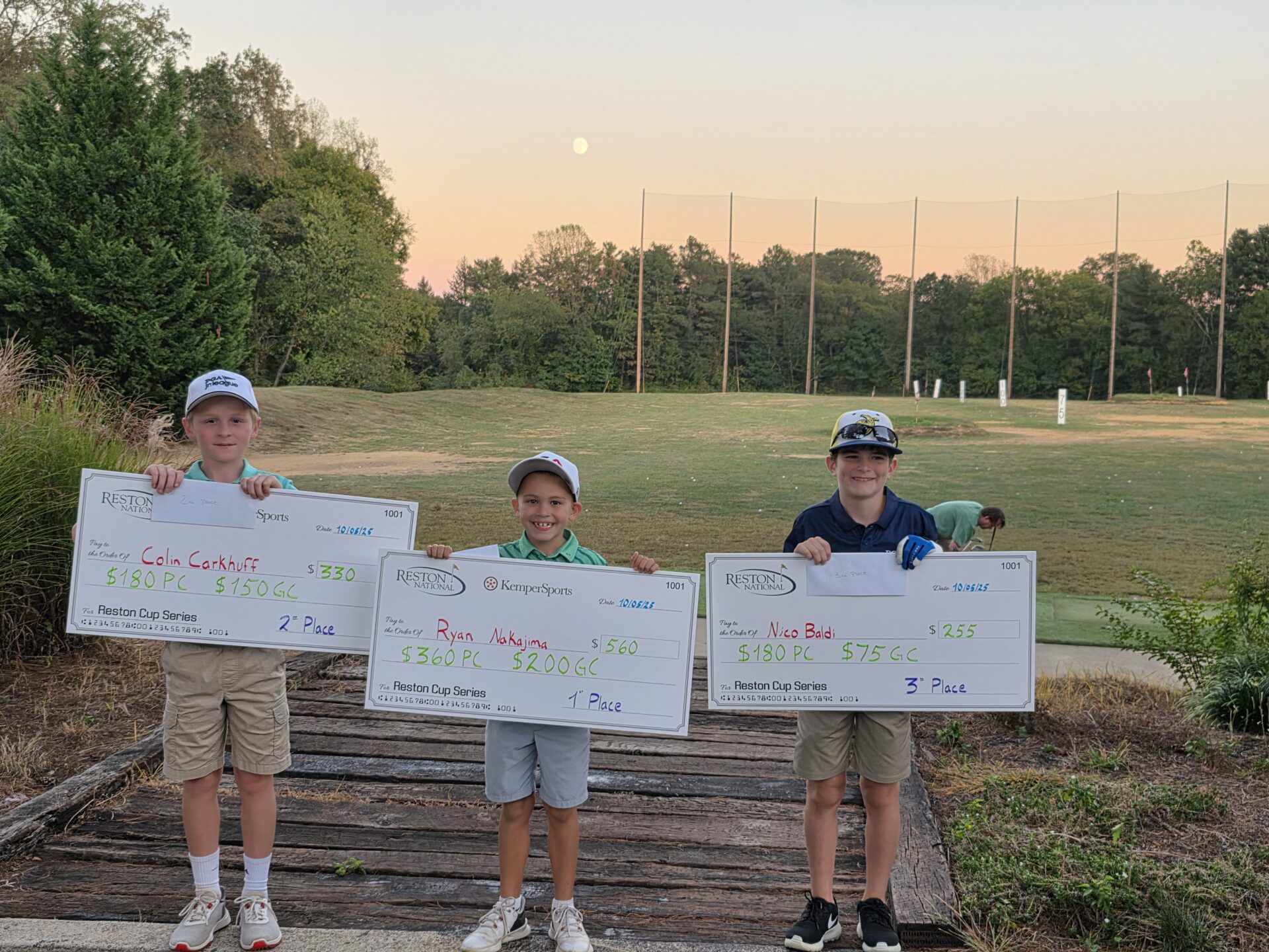 Junior golfers holding up their checks from placing in the Reston Junior Open Championship